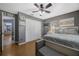 Bedroom featuring hard wood floors, ceiling fan, and an adjacent doorway at 5301 Forest Breeze Ct, St Cloud, FL 34771