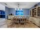 Charming dining room featuring an elegant chandelier, decorative hutch and views of the backyard at 5301 Forest Breeze Ct, St Cloud, FL 34771
