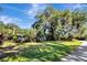 Lush landscaping surrounds this home, shaded by mature trees and a well-maintained lawn at 5301 Forest Breeze Ct, St Cloud, FL 34771