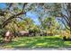 Beautifully landscaped front yard with mature trees, providing shade and enhancing curb appeal for this home at 5301 Forest Breeze Ct, St Cloud, FL 34771