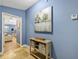 Hallway featuring stylish decor, barn art, and a glimpse into the living room and bedroom at 5301 Forest Breeze Ct, St Cloud, FL 34771