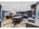 Open kitchen with stainless steel appliances, large island, and breakfast bar, with view to the living room at 5301 Forest Breeze Ct, St Cloud, FL 34771