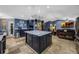 Large kitchen with a center island, stainless steel appliances, and eat-in bar, open to living area at 5301 Forest Breeze Ct, St Cloud, FL 34771