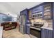 Charming kitchen featuring blue cabinetry, stainless steel appliances, and seamless connection to a cozy living space at 5301 Forest Breeze Ct, St Cloud, FL 34771