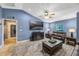 Comfortable living room with a large tv, leather sofa, area rug and lots of light at 5301 Forest Breeze Ct, St Cloud, FL 34771