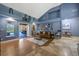 Bright living room with a comfortable seating arrangement, hardwood floors, and a seamless transition to the outdoor space at 5301 Forest Breeze Ct, St Cloud, FL 34771