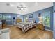 Spacious main bedroom featuring wood floors, abundant natural light, and a comfortable seating area at 5301 Forest Breeze Ct, St Cloud, FL 34771