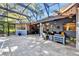 Spacious screened patio features comfortable seating, outdoor decor, a built-in grill and overlooks the lush backyard at 5301 Forest Breeze Ct, St Cloud, FL 34771