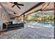 Inviting covered patio with comfortable seating, string lights and a screened-in pool area, perfect for outdoor living at 5301 Forest Breeze Ct, St Cloud, FL 34771