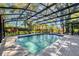 Backyard swimming pool featuring a screened enclosure and beautiful landscaping, providing privacy and enjoyment at 5301 Forest Breeze Ct, St Cloud, FL 34771