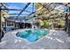 Beautiful backyard pool featuring a screened enclosure, patio, and manicured landscaping, creating a private retreat at 5301 Forest Breeze Ct, St Cloud, FL 34771