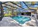 Backyard pool is enclosed with an extended, screened patio and lush garden creating a private outdoor oasis at 5301 Forest Breeze Ct, St Cloud, FL 34771