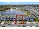 Stunning aerial view of a home in a lakeside community with lush landscaping and a paver driveway at 5648 Cedar Chase Dr, St Cloud, FL 34771