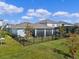 Fenced backyard features a screened-in patio and well-maintained lawn at 5648 Cedar Chase Dr, St Cloud, FL 34771