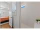 Bright bathroom featuring a walk-in shower with white tile and a glimpse of the bedroom beyond at 5648 Cedar Chase Dr, St Cloud, FL 34771