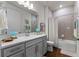 Well-lit bathroom featuring a modern vanity with white countertop and gray cabinets, plus a shower/tub combo at 5648 Cedar Chase Dr, St Cloud, FL 34771