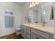 Bathroom with a double sink vanity, modern fixtures, a toilet, and a beach themed wall art at 5648 Cedar Chase Dr, St Cloud, FL 34771
