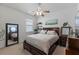 Comfortable bedroom features a dark wood bed frame, bright natural light, and neutral wall color at 5648 Cedar Chase Dr, St Cloud, FL 34771