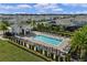 Inviting community pool with a spacious deck, lounge chairs, and a shaded cabana area at 5648 Cedar Chase Dr, St Cloud, FL 34771