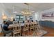Open-concept dining room with stylish light fixture and views of the backyard at 5648 Cedar Chase Dr, St Cloud, FL 34771