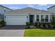 Charming single-Gathering home boasting a brick driveway, 2-car garage, and lush green lawn at 5648 Cedar Chase Dr, St Cloud, FL 34771