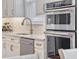 Bright kitchen features stainless steel appliances, wine rack and white cabinets and countertops at 5648 Cedar Chase Dr, St Cloud, FL 34771