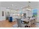 Kitchen and dining room view includes an island, stainless appliances, and open to the dining room at 5648 Cedar Chase Dr, St Cloud, FL 34771
