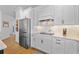 Well-appointed kitchen with white cabinetry and stainless steel refrigerator at 5648 Cedar Chase Dr, St Cloud, FL 34771