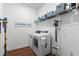 Organized laundry room equipped with modern washer and dryer, shelving, and a convenient vacuum storage at 5648 Cedar Chase Dr, St Cloud, FL 34771