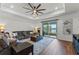 Spacious living room with wood flooring, ceiling fan and sliding glass doors to the patio at 5648 Cedar Chase Dr, St Cloud, FL 34771