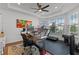 Bright office with a tray ceiling, desk, treadmill and weight lifting equipment and large windows at 5648 Cedar Chase Dr, St Cloud, FL 34771