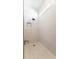 Modern shower featuring white textured tile, a small window, and a shower head at 5648 Cedar Chase Dr, St Cloud, FL 34771