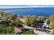 Breathtaking aerial view of a property near a serene lake, showcasing lush greenery and neighborhood charm at 609 W Osceola St, Clermont, FL 34711
