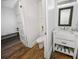 Bathroom with hardwood floors, sink, and view to an adjacent toilet room at 609 W Osceola St, Clermont, FL 34711