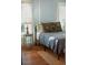 Cozy bedroom with hardwood floors, soft lighting, and comfortable furnishings, creating a relaxing retreat at 609 W Osceola St, Clermont, FL 34711