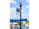 Downtown Clermont banner, playground, and blue sunshade on a sunny day at 609 W Osceola St, Clermont, FL 34711