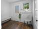 Entryway with white door, side window, bench seating, and hardwood floors at 609 W Osceola St, Clermont, FL 34711