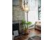 Close up of a brick fireplace with decorative items and a glimpse of the living room at 609 W Osceola St, Clermont, FL 34711