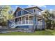 Stunning two-story home showcases a spacious porch, complemented by lush green lawns and rock landscaping at 609 W Osceola St, Clermont, FL 34711