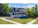 Charming blue two-story home featuring a welcoming front porch and a beautifully landscaped yard at 609 W Osceola St, Clermont, FL 34711