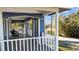 Relaxing covered front porch featuring outdoor seating and a grill, perfect for enjoying the neighborhood views at 609 W Osceola St, Clermont, FL 34711