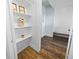 Hallway with hardwood floors leading to entry; decorative shelving on the left at 609 W Osceola St, Clermont, FL 34711