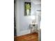 Hallway features stylish decor, including a unique painting and a modern side table with a lamp at 609 W Osceola St, Clermont, FL 34711