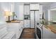 Bright kitchen with white cabinets, butcher block counters, and stainless steel appliances at 609 W Osceola St, Clermont, FL 34711