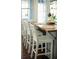 Close up of the kitchen with white high top chairs and a butcher block island at 609 W Osceola St, Clermont, FL 34711