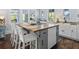 Beautiful kitchen with a butcher block island, white cabinets, and modern appliances at 609 W Osceola St, Clermont, FL 34711