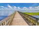 Scenic view of wooden pier extending into a calm lake under a blue sky at 609 W Osceola St, Clermont, FL 34711