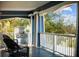 Covered porch featuring an outdoor cooking station, seating, and views of the surrounding greenery at 609 W Osceola St, Clermont, FL 34711