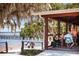 Outdoor dining area with patrons enjoying lakeside views at a waterfront restaurant at 609 W Osceola St, Clermont, FL 34711