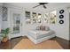 Sun room with multiple windows, day bed, area rug, and views to the back yard at 609 W Osceola St, Clermont, FL 34711